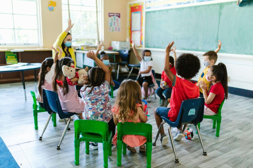 Teacher with small group of children, highlighting care ratio.